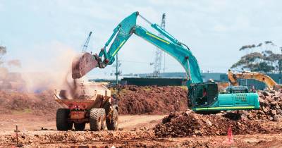 Excavator digging and loading