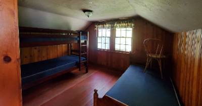 Lodge building upper floor bedroom with twin beds